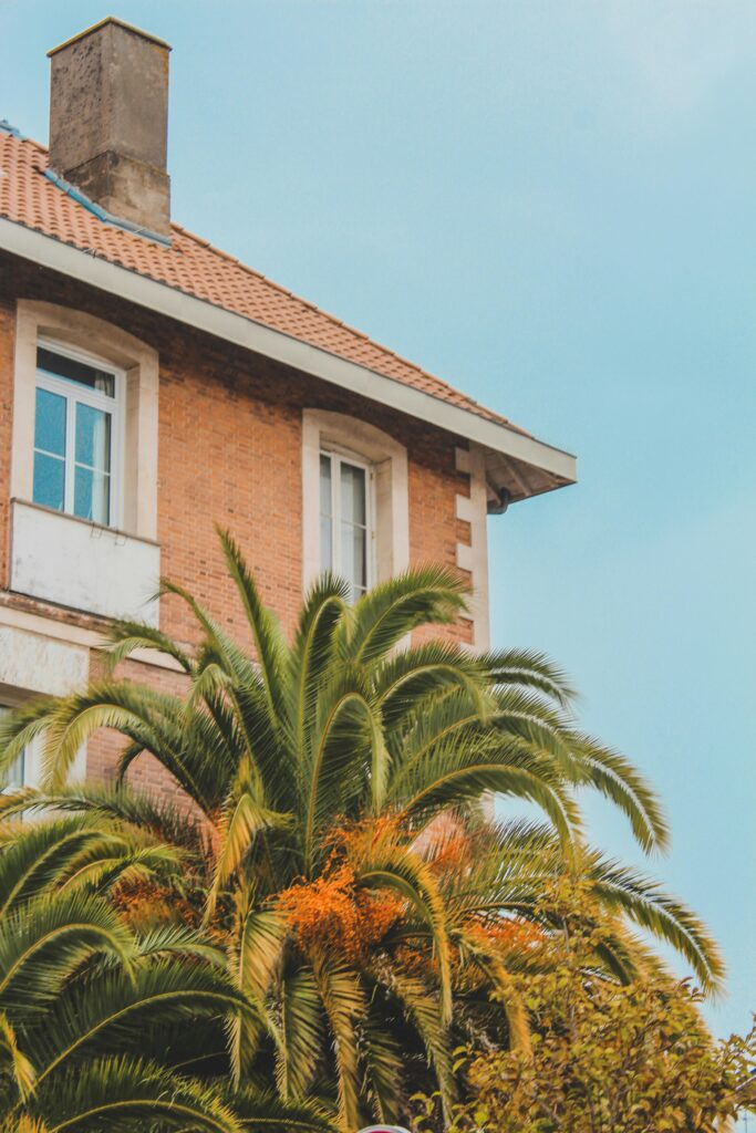Elegant French house with brick exterior and palm trees in Arcachon, France